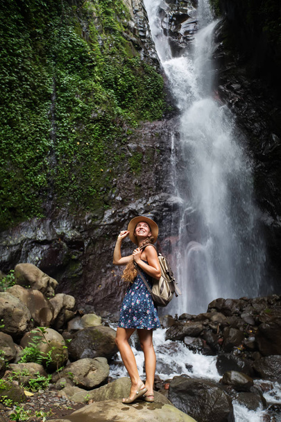 Woman near waterfal on Bali, Indonesia  - Photo, Image