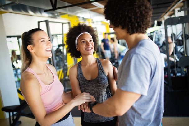 Happy group of fit people training in gym - Фото, зображення