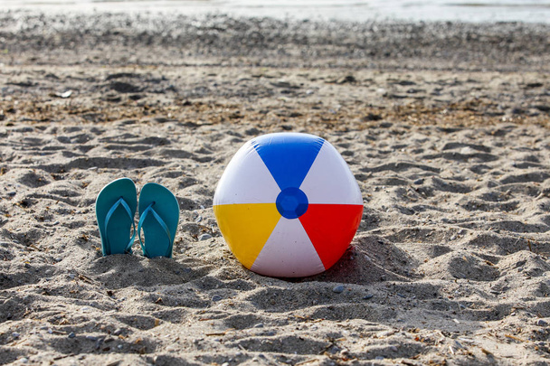 Flip flopit rannalla hiekkaa värikäs ranta pallo
 - Valokuva, kuva