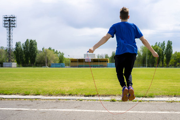 male athlete sportsman practice with jump rope at the outdoor stadiums, increase stamina - Foto, Imagen
