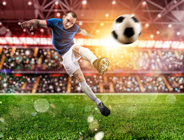 Football scene at night match with player kicking the ball with power. - Photo, Image