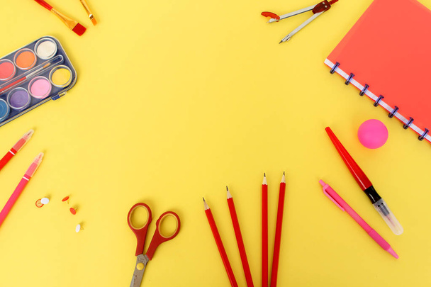 Colored school various stationery, paints, pencils, pens, on a yellow background. Back to school concept, top view, copy space - Foto, immagini