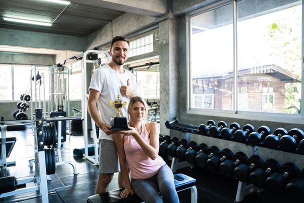 Healthy lifestyle couple working out in fitness gym - Photo, Image