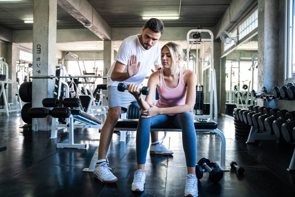 Healthy lifestyle couple working out in fitness gym - Valokuva, kuva