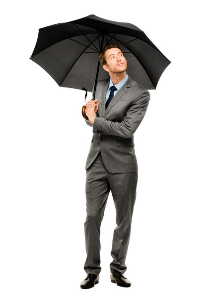 Businessman holding umbrella smiling isolated white background - Фото, изображение