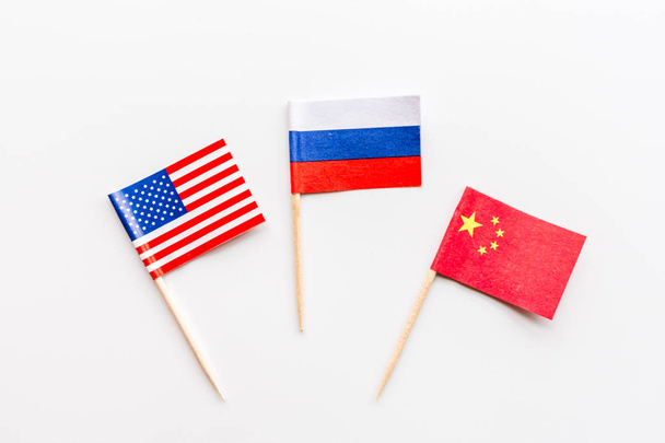 Creative top view flat lay of China, Russia and USA flags on white background in minimal style.  - Fotoğraf, Görsel