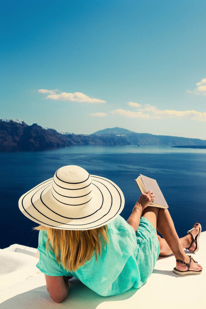 Luxury travel vacation woman looking at view on Santorini island - 写真・画像