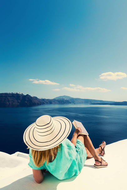 Luxury travel vacation woman looking at view on Santorini island - Фото, изображение