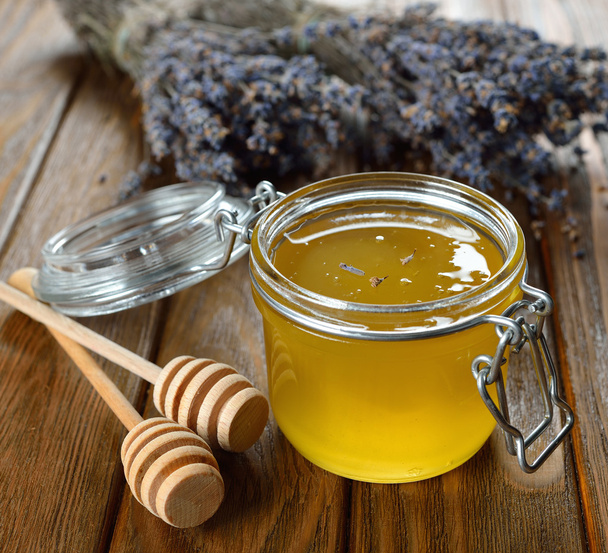 Honey in a glass jar - Фото, зображення
