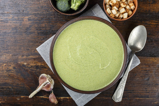 bowl of broccoli and green peas cream soup on wooden table  - Foto, immagini