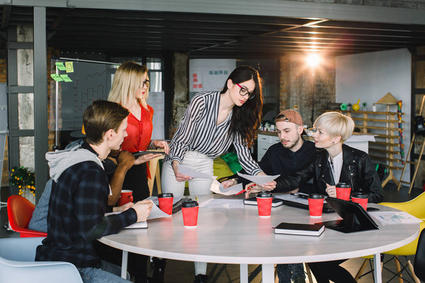 Multiethnic diverse group of creative team, casual business people, or college students in strategic meeting or project brainstorm discussion at office, using tablets. Startup or teamwork concept. - Photo, image