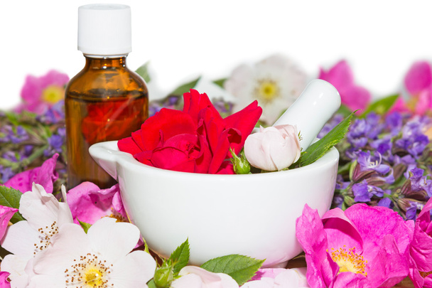 Essential oil and rose blossoms in mortar - Photo, Image