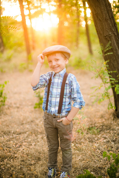 Little boy in a hat in the park in the summer at sunset - Photo, image