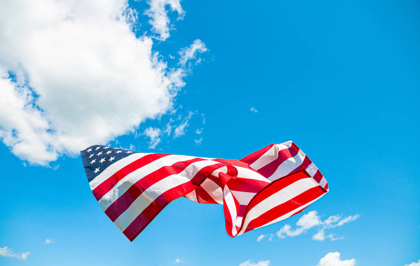 American flag in blue sky background. United States flag - Zdjęcie, obraz