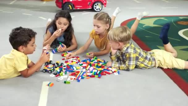 Cute kids playing constructor on the floor. - Footage, Video