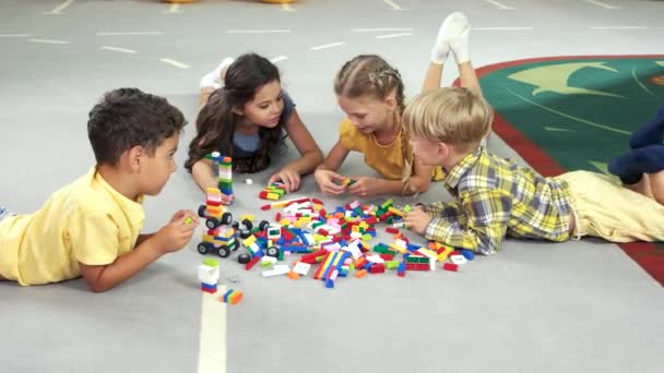 Four kids play with blocks. - Footage, Video