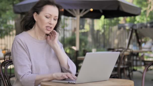 Old Woman with Neck Pain Using Laptop Outdoor - Video