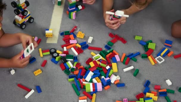Hand van kinderen spelen Toy constructor op de vloer. - Video