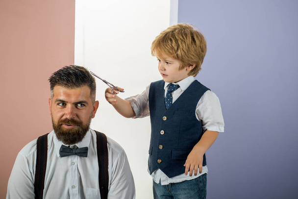 Hairdresser for father. Family business. Family barbershop. Portrait of stylish man beard. Beard man visiting hairstylist in barber shop. - Photo, image