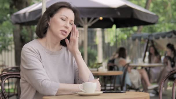 Old Woman with Headache Sitting in Outdoor Cafe - Footage, Video