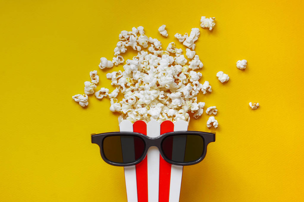 Popcorn in a red and white cardboard box with glasses for a 3D m - Photo, Image