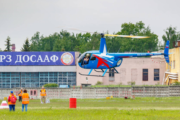 Balashikha, Moscow region, Russia - May 25, 2019: Helicopter races by helicopter Robinson R44 Raven RA-06227 at the Aviation festival Sky Theory and Practice 2019 on airfield Chyornoe - Fotó, kép