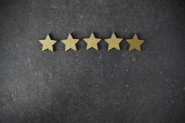 five golden stars on dark background, top rating concept - Фото, изображение