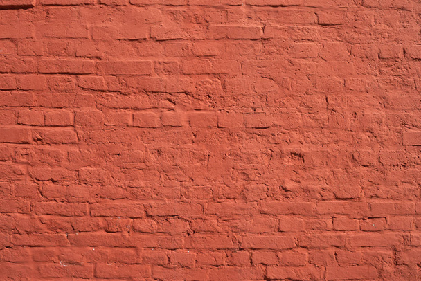 Red brick wall with smooth seams, covered with lime or plaster - Photo, Image
