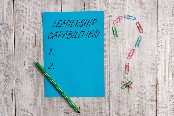 Handwriting text Leadership Capabilities. Concept meaning Set of Perforanalysisce Expectations a Leader Competency Pastel colour note paper placed next to stationary above the wooden table. - Photo, Image