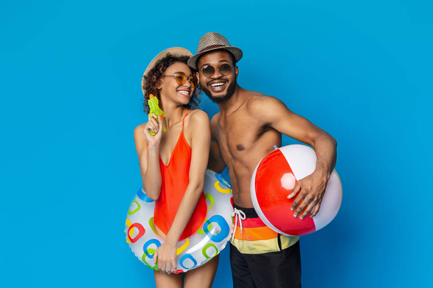 African couple in swimwear holding beach toy - Zdjęcie, obraz