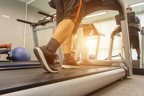 Men are exercising by running on a treadmill after working in an - Foto, Bild