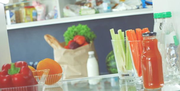 Open refrigerator with fresh fruits and vegetable. Open refrigerator - Fotoğraf, Görsel