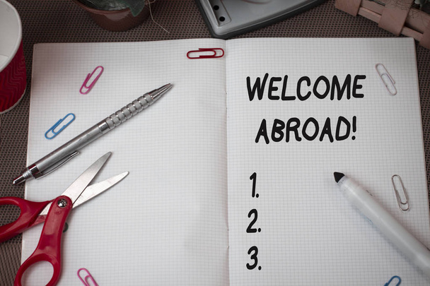 Text sign showing Welcome Abroad. Conceptual photo something that you say when someone gets on ship Scissors and writing equipments plus math book above textured backdrop. - Photo, Image