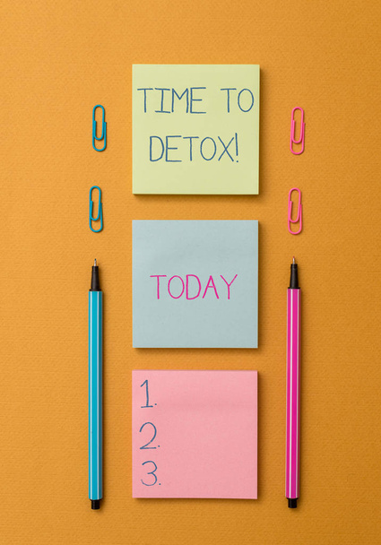Word writing text Time To Detox. Business concept for when you purify your body of toxins or stop consuming drug Front view blank colored sticky note two ballpoints clips yolk background. - Photo, Image
