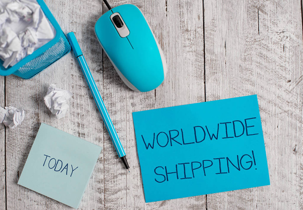 Conceptual hand writing showing Worldwide Shipping. Business photo showcasing Sea Freight Delivery of Goods International Shipment Crumpled paper in bin and computer mouse on wooden backdrop. - Photo, Image