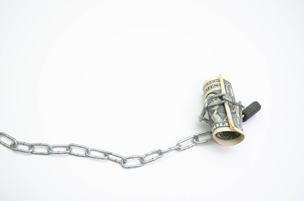 Banknotes tied to chains with lock White background.Do not focus on objects - Foto, Imagen