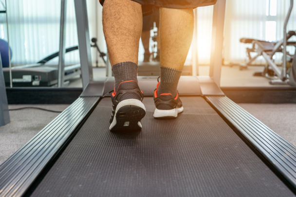 Men are exercising by running on a treadmill after working in an - Foto, Bild