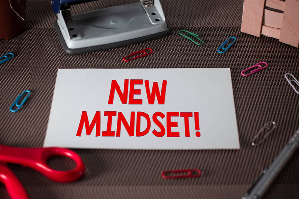 Text sign showing New Mindset. Conceptual photo mental attitude of demonstratings responses to certain situations Scissors and writing equipments plus plain sheet above textured backdrop. - Fotó, kép