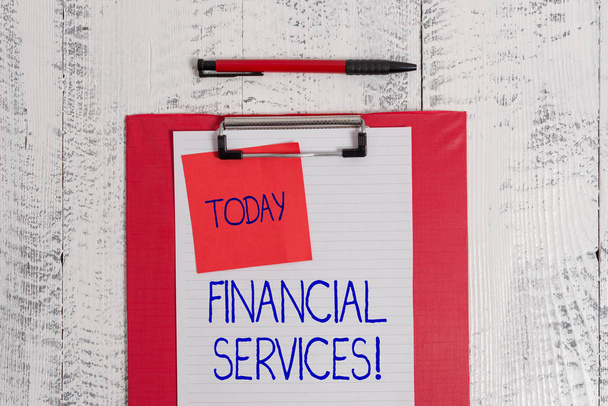 Writing note showing Financial Services. Business photo showcasing Money and Investment Leasing Lending Stocks Brokerages Clipboard paper sheet sticky note ballpoint vintage wooden background. - Photo, Image