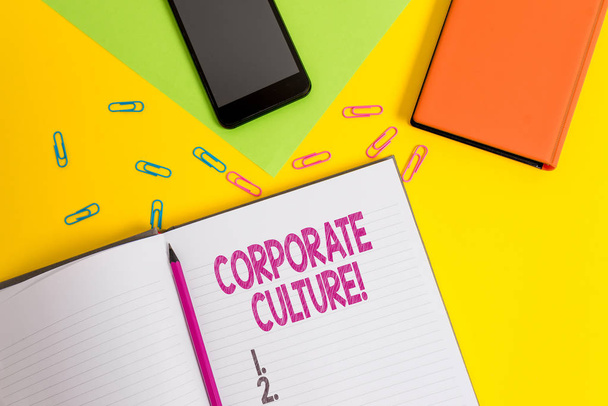 Handwriting text Corporate Culture. Concept meaning Beliefs and ideas that a company has Shared values Blank paper sheet pencil clips smartphone two notepads colored background. - Photo, Image