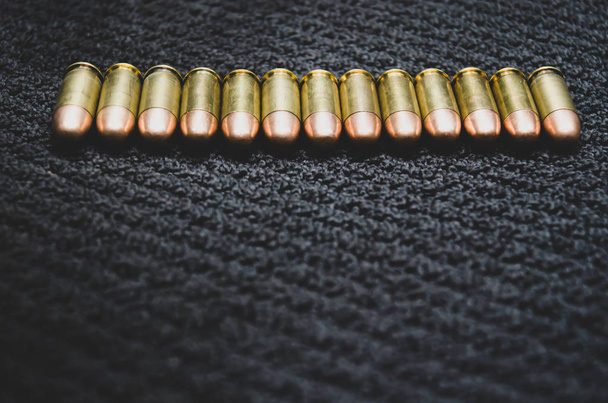 Ammunition laid on black ground. - Photo, image