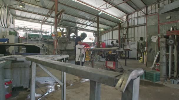 Slow motion of a welder welding construction steel frames - Footage, Video