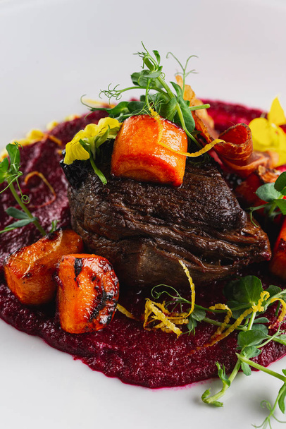 Fried duck breast with vegetables and beetroot puree served on white plate - Photo, Image