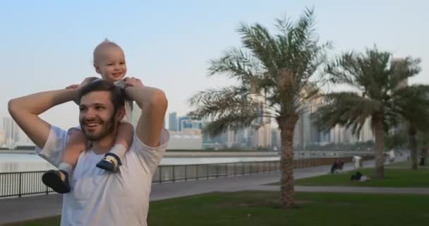 Père marchant avec un enfant assis sur le cou
 - Séquence, vidéo