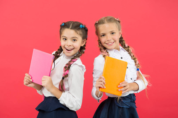Schoolgirl show diary notepad. School supplies concept. School stationery. Buy cute stationery for fun studying. Girls kids school uniform hold book. Girls famous for obsession with stationery - Foto, Imagem