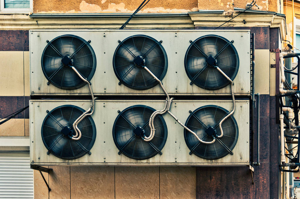 Industriële airconditioner systeem gemonteerd op oude Mall muur met veel verbindingsleidingen over - Foto, afbeelding