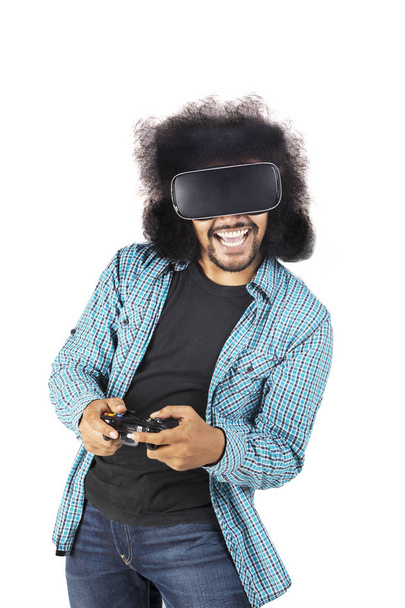 Happy man playing video games with VR glasses - Foto, Bild