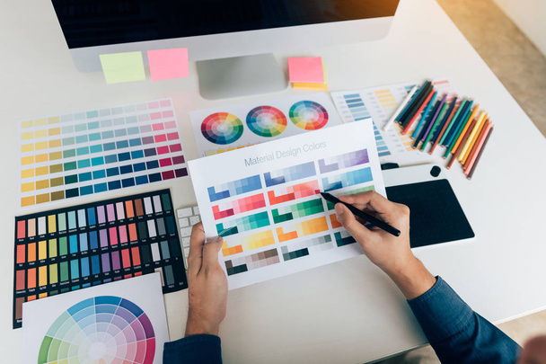 Χέρι σχεδιαστή επιλογή χρωμάτων για να κάνει γραφικών σε laptop. - Φωτογραφία, εικόνα