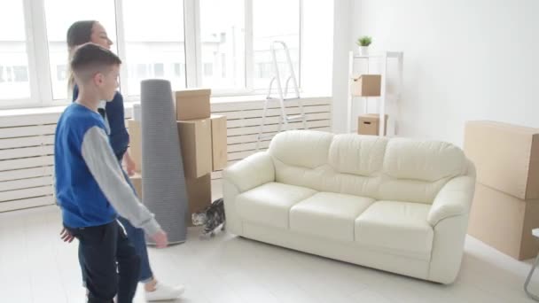 Young Mom and son are moving to a new apartment - Footage, Video