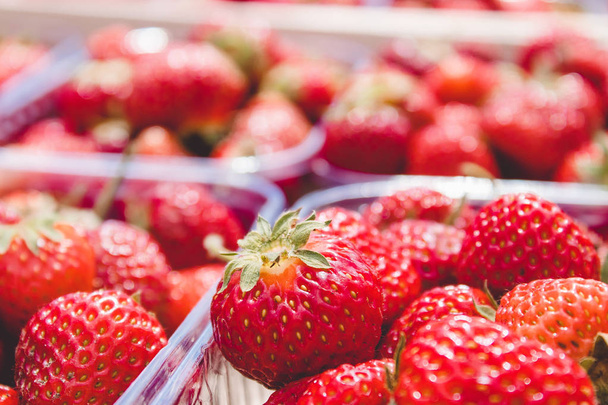 Portion boîtes de fraises juteuses fraîches dans des boîtes en plastique
. - Photo, image